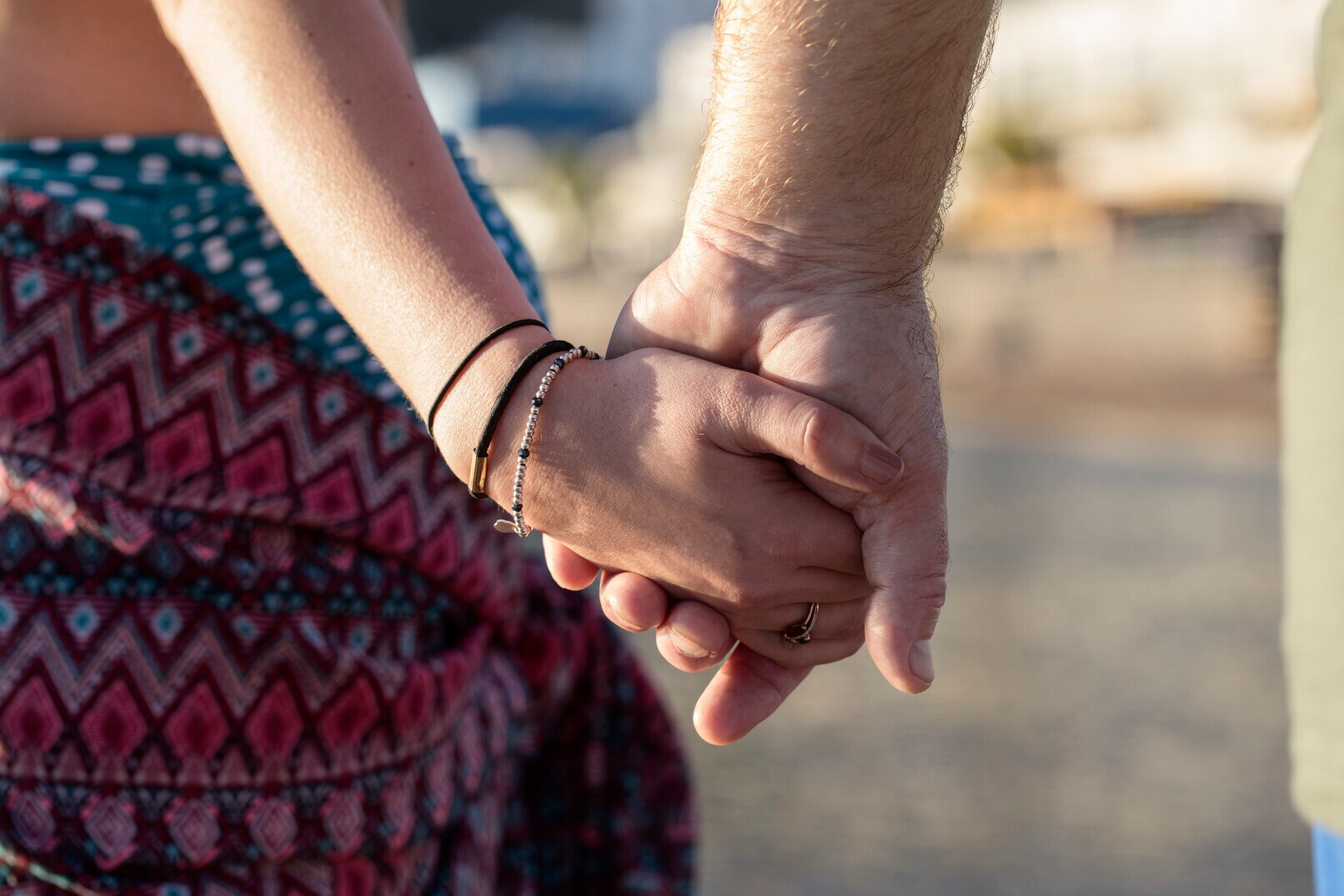 Couple holding hands. Men living with MS may experience premature ejaculation, erectile dysfunction, and decreased sensation.