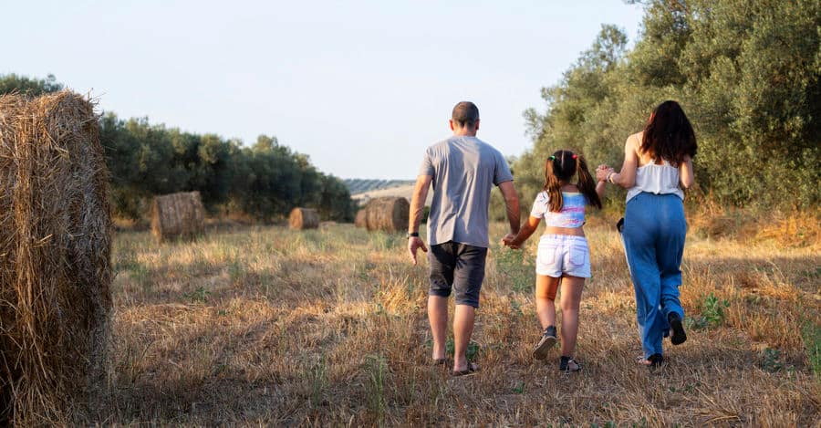Photo of Andrea walking with his family. Andrea uses Peristeen Plus to help manage his bowel issues. 