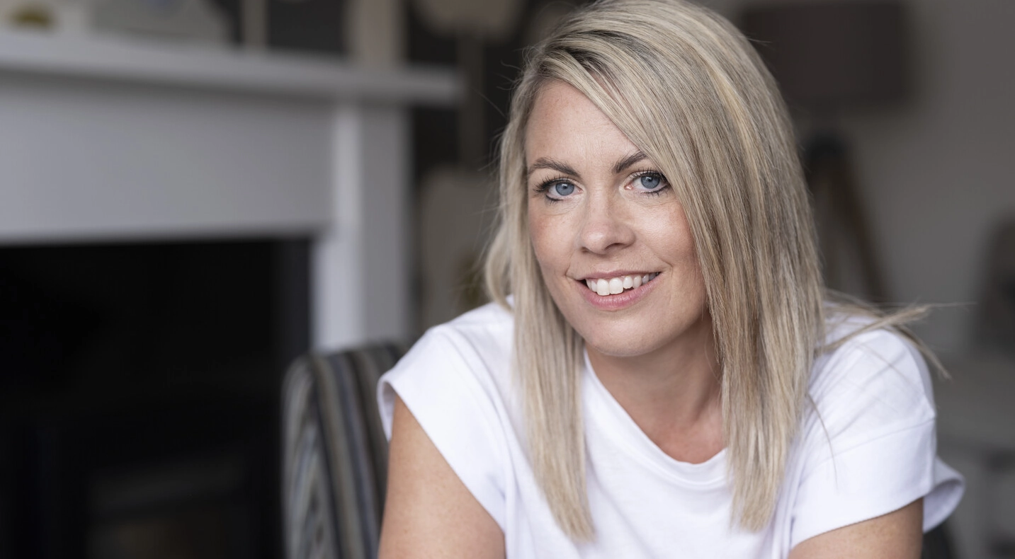 Laura, a SpeediCath® Compact Eve and Peristeen® Plus user, sits in her living room. 